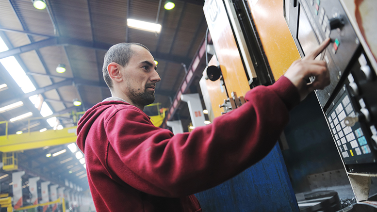 A factory worker utilizes a Programmable Logic Controller (PLC) to execute a production process. PLC operation is one of the areas of instruction Ivy Tech offers within their School of Advanced Manufacturing, Engineering & Applied Science. Photo by: story blocks