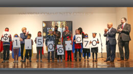 Campaign co-chairs Liz Ludwick and Damon Elmore reveal the dollars raised. Photo by: Lorri Markum