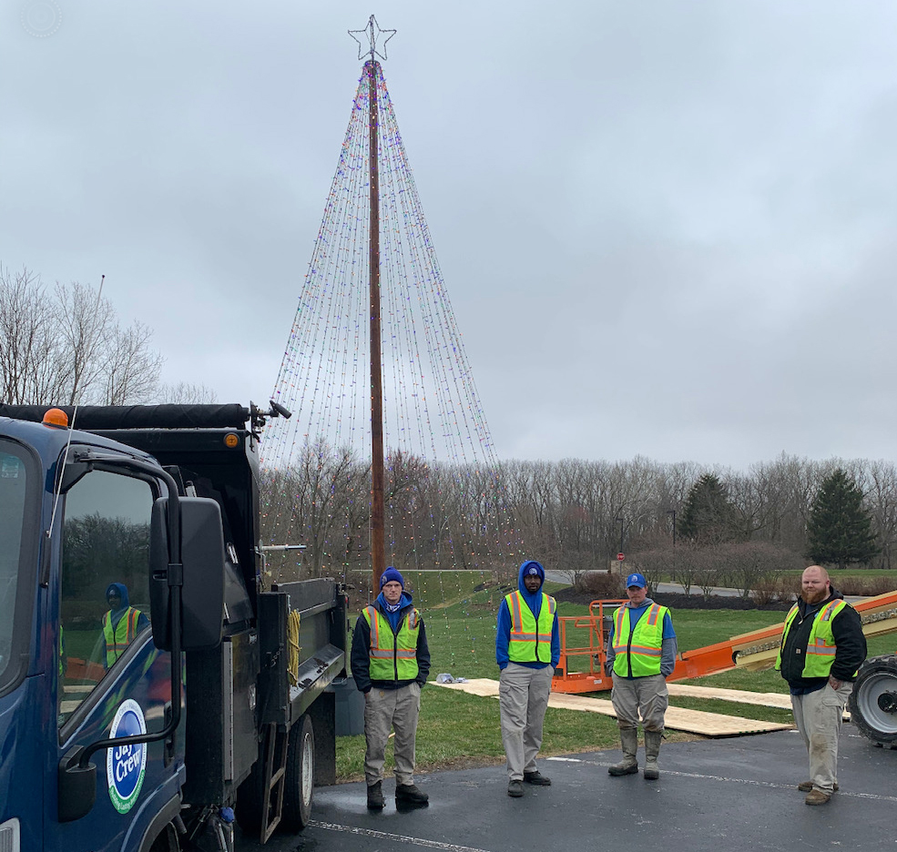 Jay Crew staff are pictured after re-installing the tree on Monday. Photo provided