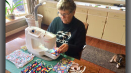 Volunteers like Nancy Carlson are among local theater seamstresses making masks. Photo by: John Carlson