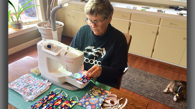 Volunteers like Nancy Carlson are among local theater seamstresses making masks. Photo by: John Carlson
