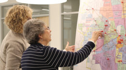 Attendees view a map of Muncie neighborhoods during the IDEA conference. The attendees pinpointed where they live and where they love with a string connecting the two. Photo provided.