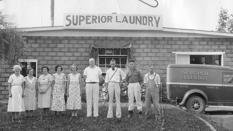 Frances and Charles Marsh stand side by side in the center in front of their business in 1935 in Muncie. On the truck you can see the phone number of Superior Laundry - 911. Photo provided