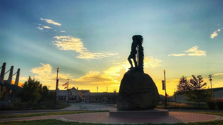 Downtown Muncie's iconic sculpture, “Passing of the Buffalo” standing tall at dawn. Photo by: Matt Howell, Farmhouse Creative