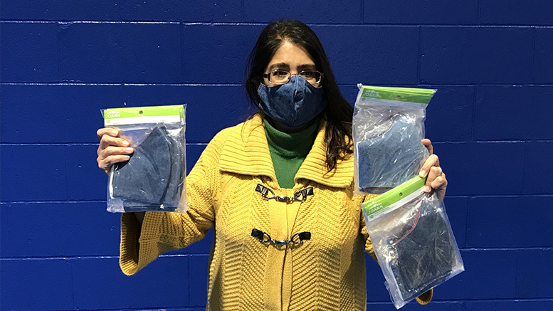 Ross Center’s Executive Director Jacqueline Hanoman receives 620 masks from non-profit Classroom Connections of ECI. Photo by Stacy Wheeler