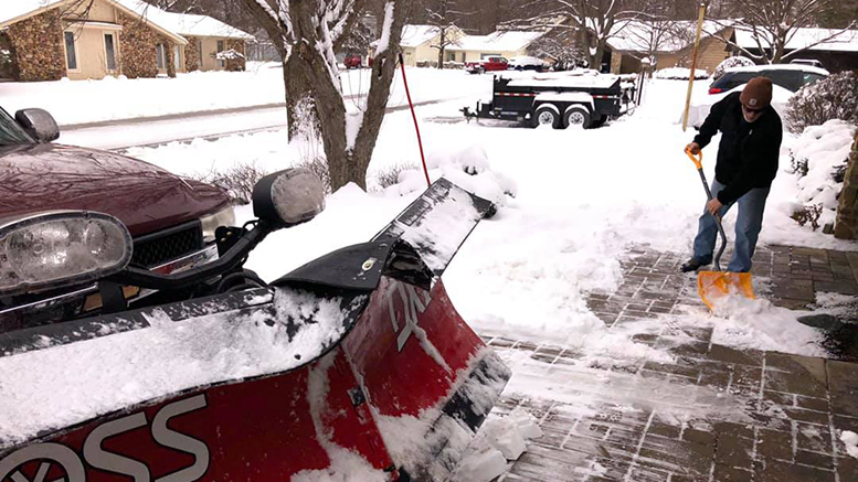 Tracy Rabel is pictured removing snow from the Rhodes residence. Photo by Mike Rhodes