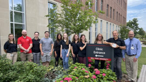 Dr. Leonard Kaminsky (second from right), Administrative Director of the Healthy Lifestyle Center (HLC) accepts the Healthy Community Alliance of East Central Indiana’s “100,000 Award” award on behalf of the HLC and Ball State University’s College of Health. Healthy Lifestyle Center team members posed in front of Ball State’s Health Professions Building July 12th to accept the award from John Disher (far right), Director of Community Outreach for IU Health’s East Central Region and Facilitator of the Healthy Community Alliance of East Central Indiana. Photo by Matthew S. Cox.