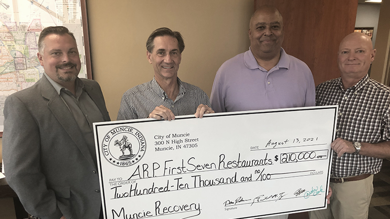 L-R: Special projects manager for the City of Muncie, Dustin Clark; Mayor Dan Ridenour; Deputy Mayor Richard Ivy; and the City of Muncie Controller Craig Wright are pictured with a check for the first release of funds, which totaled nearly $210,000.
