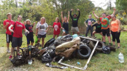 Canoe group volunteers pose with their haul of trash rescued from the White River at the 2017 clean-up event.