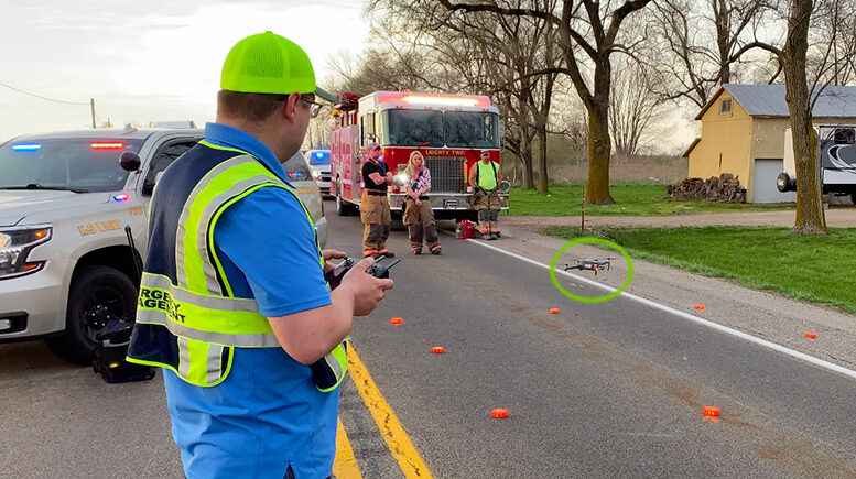 Emergency management personnel are pictured during a drone training session. The DJI drone (circled) is hovering just above the ground. Photo provided