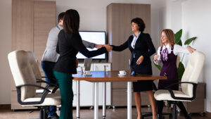 A human resources executive meets with new employees in a conference room. Photo by story blocks.