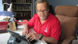 John Carlson is pictured writing one of his MuncieJournal.com columns using his iPad. Photo by Nancy Carlson