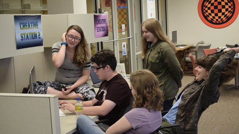 tudents in a previous Summer Film School are shown with camera equipment and working together to edit a video. Photo by Noelle Sherrell, MPL