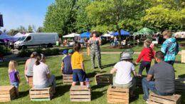 Katie Lehman, Ready Readers Supervisor at MPL, conducts an outside story time at the recent Garden Fair at Minnetrista Museum & Gardens. Photo by Sidney Barkdull, Ready Readers Specialist at MPL.