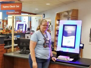 Laura Geesy, MPL employee, with one of the new RFID checkout units. Photo by Susan Fisher