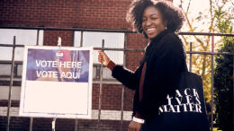 A woman is pictured standing in line to vote. Photo by storyblocks