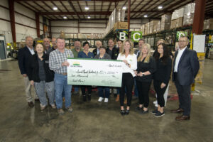 Members of the Co-alliance Cooperative of Indianapolis, stand in front of the pallets of cheese donated by Land O' Lakes. The Co-alliance donated $2,000 to Second Harvest. Photo by Mike Rhodes