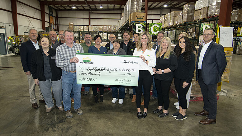 Members of the Co-Alliance Cooperative of Indianapolis, stand in front of the pallets of cheese donated by Land O' Lakes. The Co-alliance also donated $2,000 to Second Harvest. Photo by Mike Rhodes