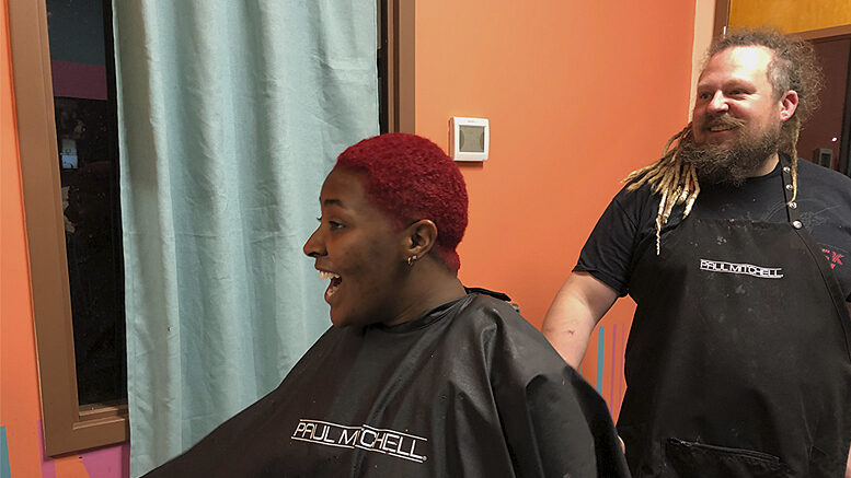 Event Coordinator SteVen Knipp looks on as a client admires her new hairstyle at SteVen Knipp Hair Studio, located at Madjax. Photo by Emily Helms.