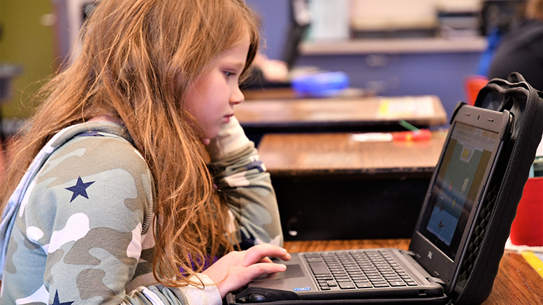 A Grissom Elementary student is pictured using her computer in class. Photo provided