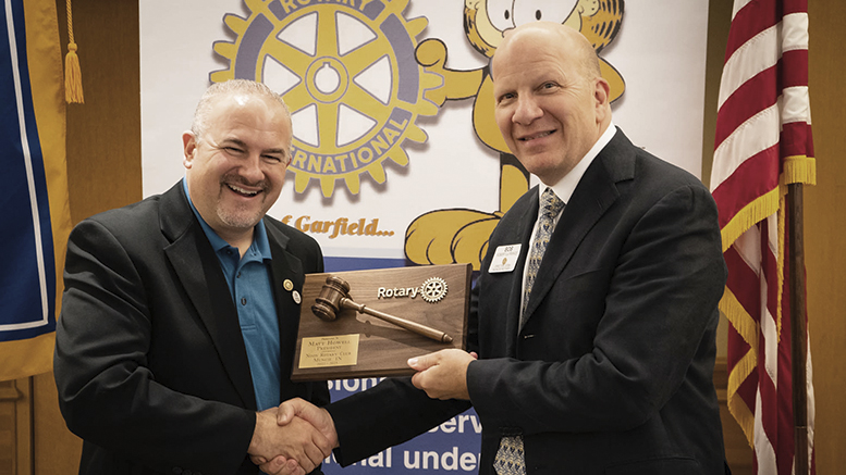 Immediate Past President Matt Howell passes the gavel to incoming President Robert G. La France. Photo provided