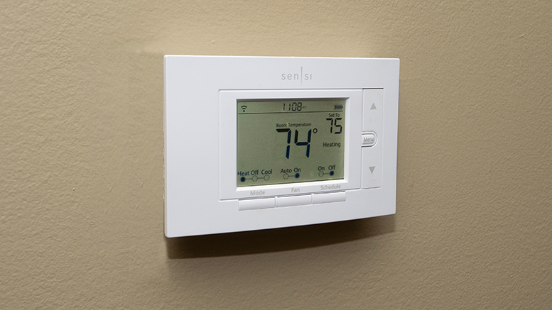 A smart thermostat that can be controlled by a cellular phone is pictured.