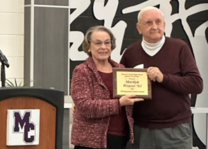 Forrest Bowers, a 1957 graduate of Muncie Central and chairman of the Muncie Central Alumni Association’s Distinguished Alumni Committee, presents Marilyn Weaver, 1961, with her Distinguished Alumni Award plaque.