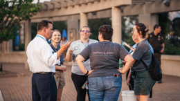Brian is pictured on the far left as he speaks to a group. Photo provided