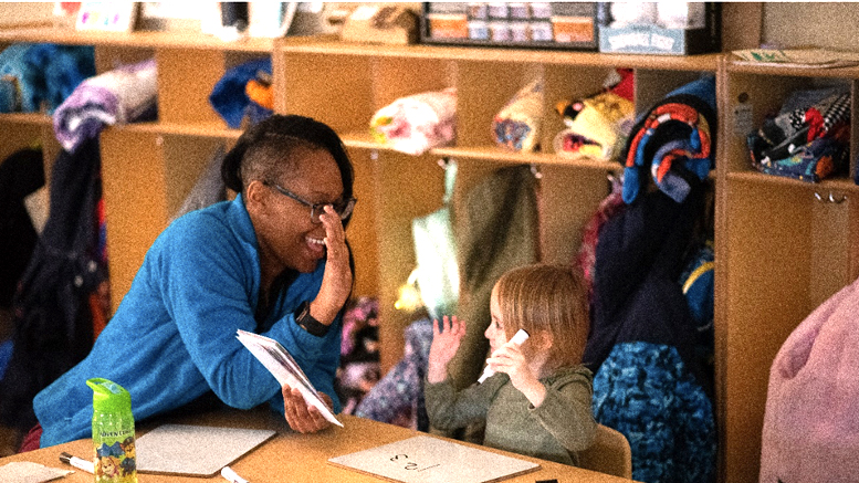 Grissom Elementary School educator and student work together on the alphabet. Photo by Maggie Manor.