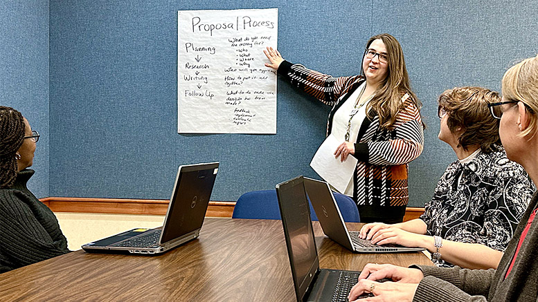 Laura Janiga, MPL employee, reviews the Grant Writing Learning Circle agenda with other MPL employees. Photo by Spenser Querry, MPL Webmaster and Social Media Specialist.