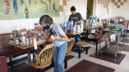 Putting away food donations. Photo by Dottie Kreps.