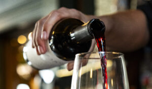 A Vera Mae's bartender pours a glass of Pinot Noir for a guest. Photo provided.
