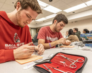Ball State and IU students practice suturing techniques as part of regional healthcare training programs supported by Ball Brothers Foundation. New grants strengthen pathways from high school to healthcare careers throughout East Central Indiana.