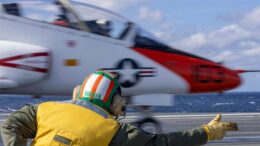 Lt. Danny “Dooner” Muldoon signals a T-45C Goshawk training aircraft attached to Training Air Wing (TW) 2 to launch off the flight deck aboard the Nimitz-class aircraft carrier USS George H.W. Bush. George H.W. Bush is underway conducting carrier qualifications and routine operations in the Atlantic Ocean. U.S. Navy photo by Mass Communication Specialist 2nd Class Nicholas Avis.