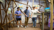 Students from the Ball State University College of Architecture and Planning stand inside the former transformer shaft at MadJax Maker Force during early construction of TOOLSONG Gallery. The space was once unused and was transformed into a new art exhibition venue through adaptive reuse and student-led design.