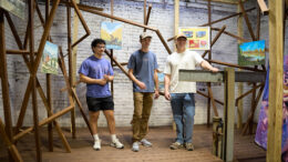 Students from the Ball State University College of Architecture and Planning stand inside the former transformer shaft at MadJax Maker Force during early construction of TOOLSONG Gallery. The space was once unused and was transformed into a new art exhibition venue through adaptive reuse and student-led design.