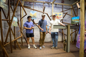 Students from the Ball State University College of Architecture and Planning stand inside the former transformer shaft at MadJax Maker Force during early construction of TOOLSONG Gallery. The space was once unused and was transformed into a new art exhibition venue through adaptive reuse and student-led design.