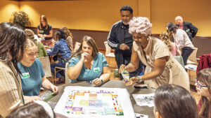 Attendees playing a special Monopoly-style game about their neighborhood. Photo by Ty Morton.
