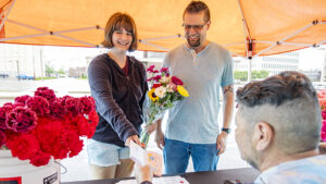 A father and daughter participate in Flower Hour during Downtown Muncie’s Brink of Summer ArtsWalk, creating a custom bouquet while exploring local stops throughout DWNTWN. Photo by Samantha Blankenship.