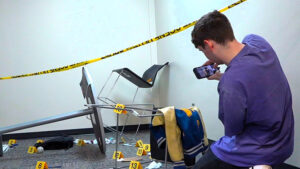MCHS senior Anthony Shank photographs evidence in a mock crime scene. Photo provided.